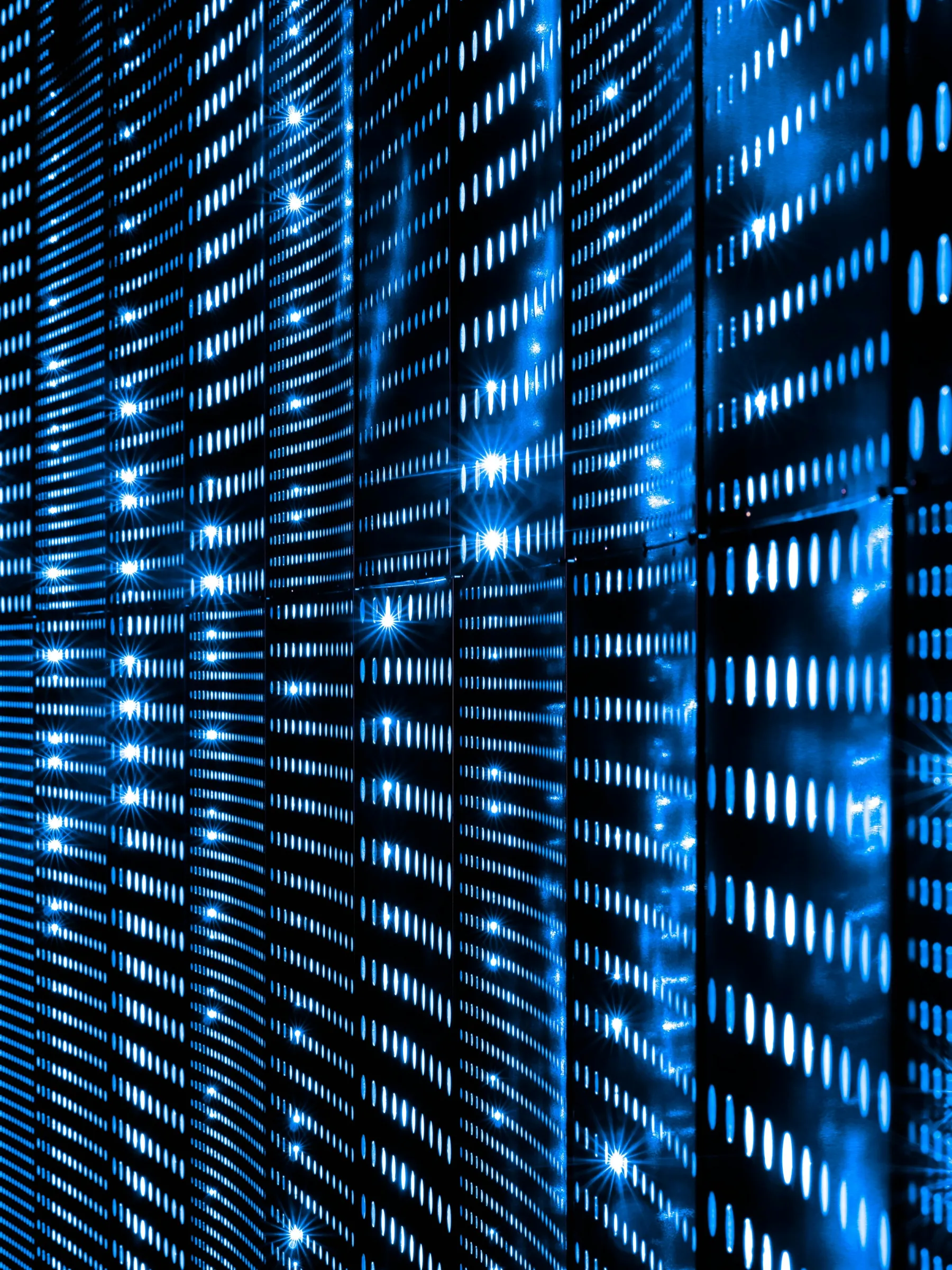 Rows of server racks glowing with blue status lights.